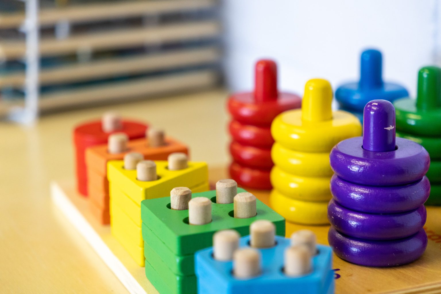 Colorful wooden stacking toys on display in a toddler classroom